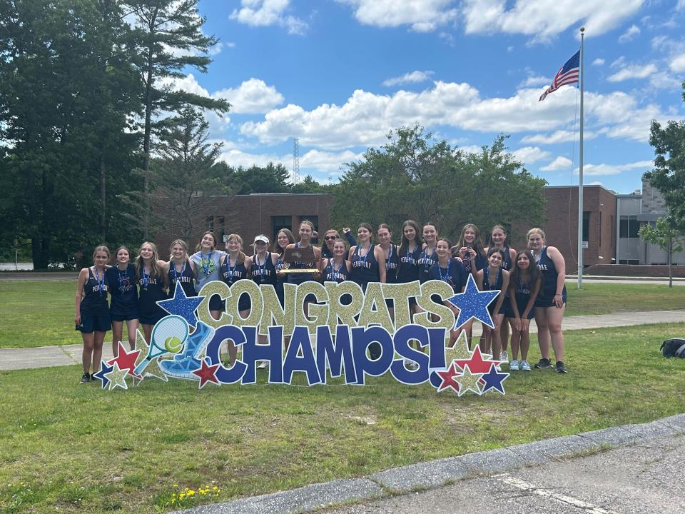 Members of the Pembroke High girls tennis team pose with the MIAA Division 3 state championship trophy back at the school after beating Weston, 3-2, at MIT's courts on Saturday, June 15, 2024.