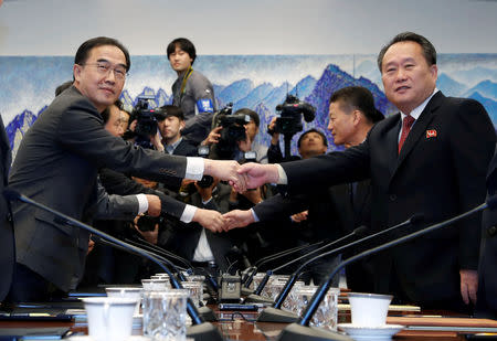 North Korea's Ri Son Gwon, chairman of the Committee for the Peaceful Reunification of the Country, shakes hands with South Korean Unification Minister Cho Myoung-gyon during their meeting at the truce village of Panmunjom inside demilitarized zone, South Korea, October 15, 2018. Korea Pool/Yonhap via REUTERS