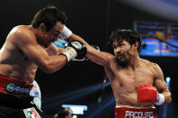 LAS VEGAS, NV - NOVEMBER 12: (R-L) Manny Pacquiao throws a right punch at Juan Manuel Marquez during the WBO world welterweight title fight at the MGM Grand Garden Arena on November 12, 2011 in Las Vegas, Nevada. (Photo by Harry How/Getty Images)