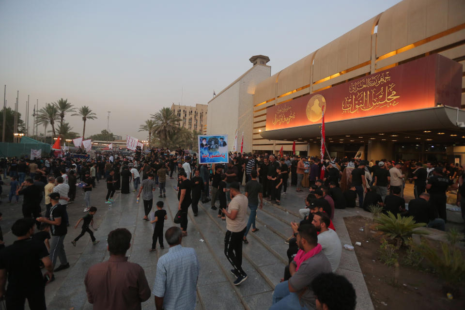 Followers of Shiite cleric Moqtada al-Sadr gather outside the parliament building during a sit-in protest, in Baghdad, Iraq, Wednesday, Aug. 3, 2022. The Influential Shiite cleric has told his followers to continue their sit-in inside Iraq's government zone, and called for the dissolution of the parliament and early elections. (AP Photo/Anmar Khalil)