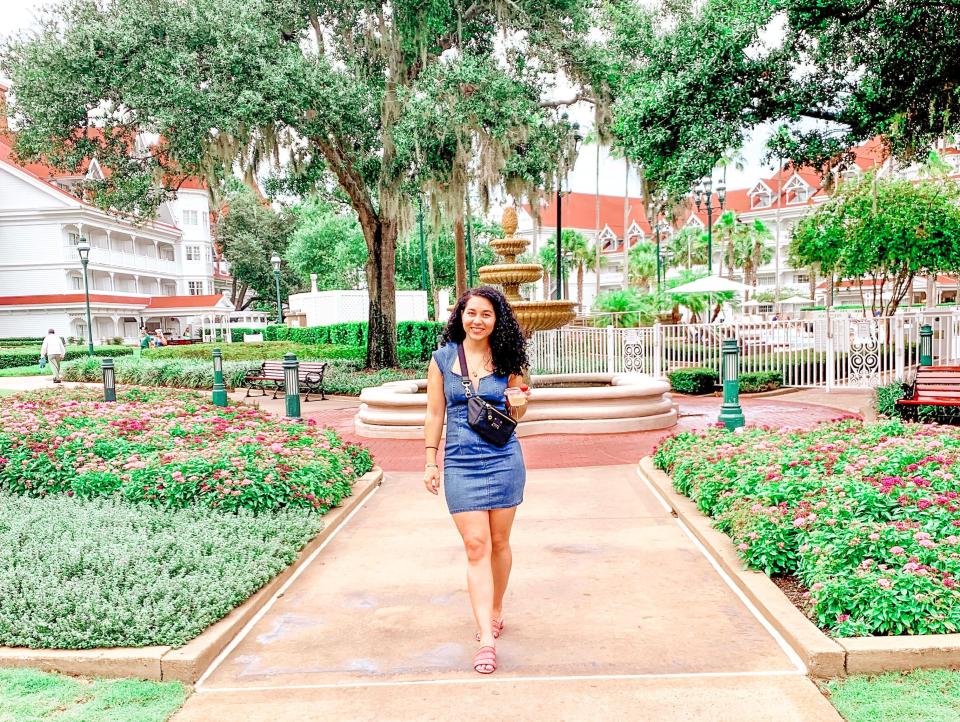 woman walking down a pathway at the grand floridian resort disney world