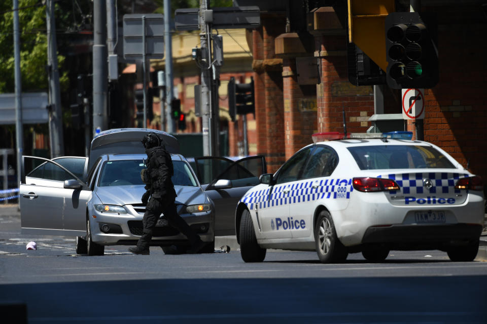 Victoria Police search a car on William Street in the Melbourne CBD.