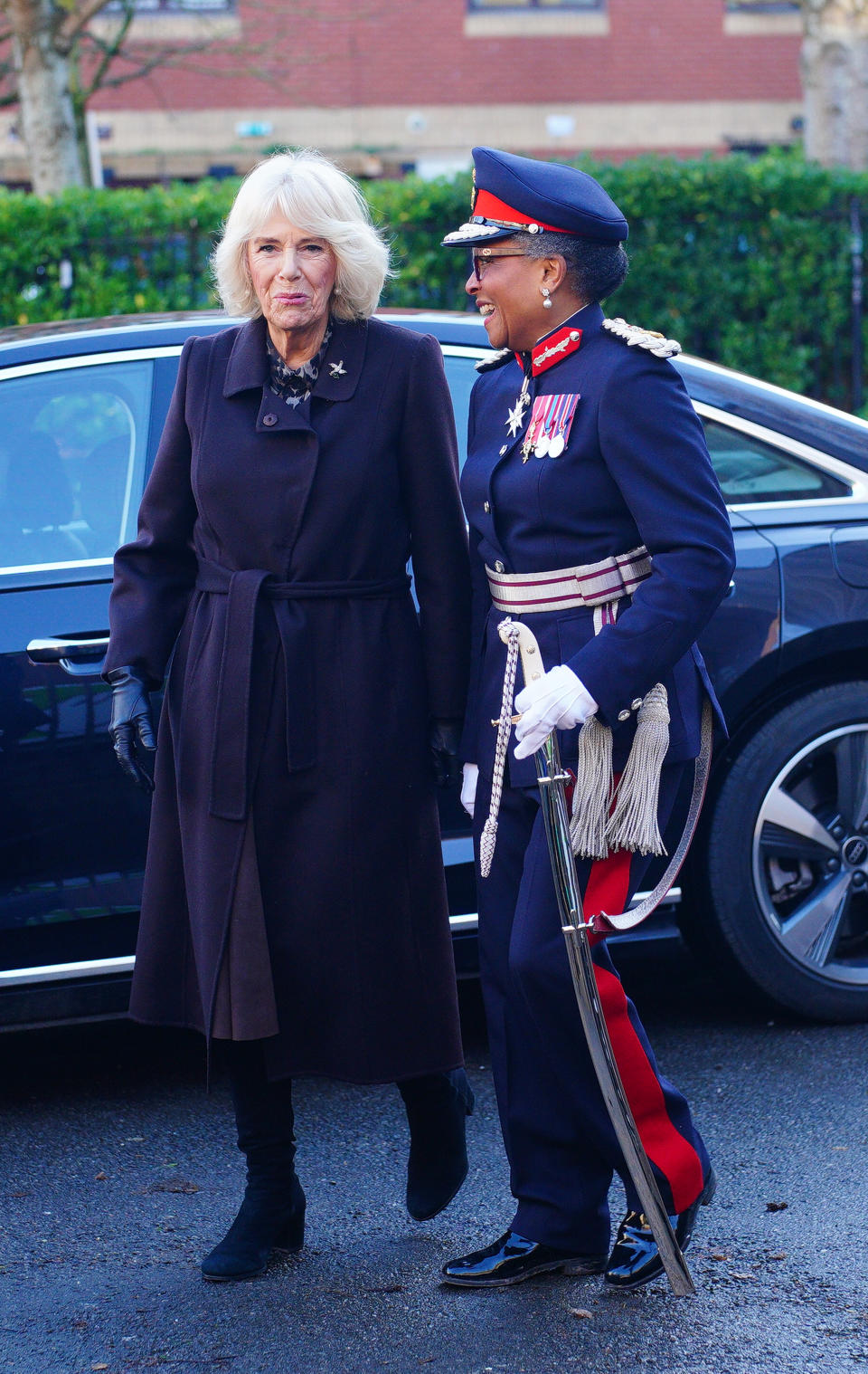 BRISTOL, ENGLAND - DECEMBER 14: Queen Camilla (left) arrives to join companions and staff to celebrate the 25th anniversary of Emmaus Bristol, at Backfields House, on December 14, 2023 in Bristol, England. (Photo by Ben Birchall - WPA Pool/Getty Images)