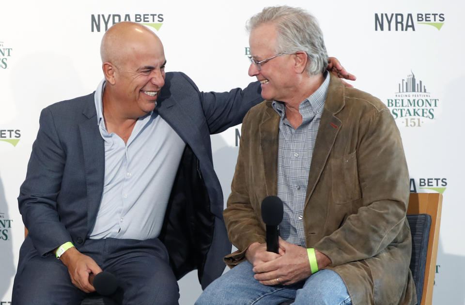 Mark Casse, left, War of Will's trainer, shares a laugh with Bill Mott, Tacitus' trainer, as they they joined Todd Pletcher and Dale Romans in a press conference following a draw ceremony for the 2019 Belmont Stakes race, Tuesday, June 4, 2019, in New York. (AP Photo/Kathy Willens)