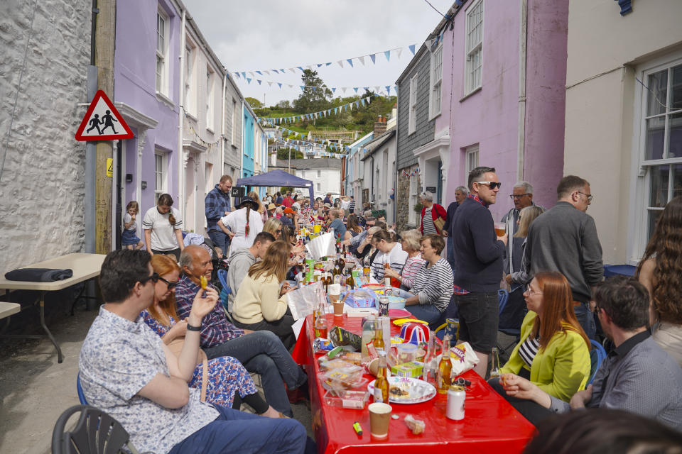 FALMOUTH, ENGLAND - MAY 07: Residents of the Cornish fishing village of Flushing enjoy a street party the day after the Coronation of King Charles III and Queen Camilla on May 07, 2023 in Flushing, Falmouth, England. People around the UK celebrate with street parties after Charles III and his wife, Camilla, were crowned as King and Queen of the United Kingdom of Great Britain and Northern Ireland, and the other Commonwealth realms. The Coronation took place yesterday at Westminster Abbey eight months after Charles acceded to the throne on 8 September 2022, on the death of his mother, Elizabeth II.  (Photo by Hugh Hastings/Getty Images)