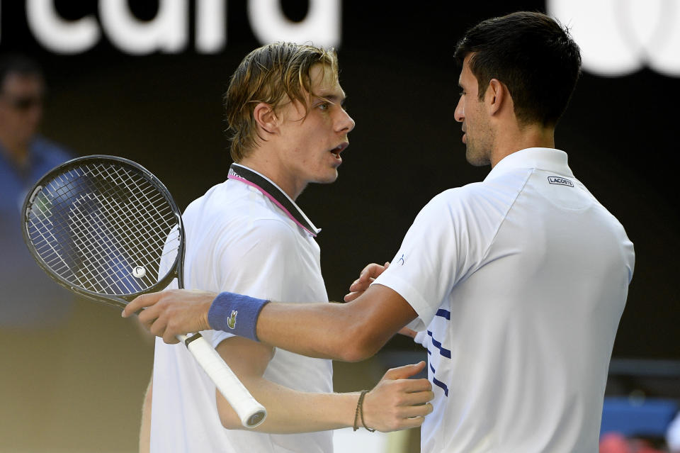 Serbia's Novak Djokovic, right, is congratulated by Canada's Denis Shapovalov after winning their third round match at the Australian Open tennis championships in Melbourne, Australia, Saturday, Jan. 19, 2019. (AP Photo/Andy Brownbill)