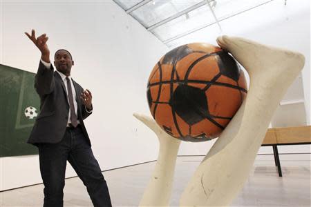 Curator Franklin Sirmans gestures near "Free Throw" by Mary Ellen Caroll during construction of the exhibition, "Futbol: The Beautiful Game", at the Los Angeles County Museum of Art (LACMA) in Los Angeles, California, January 27, 2014. REUTERS/David McNew
