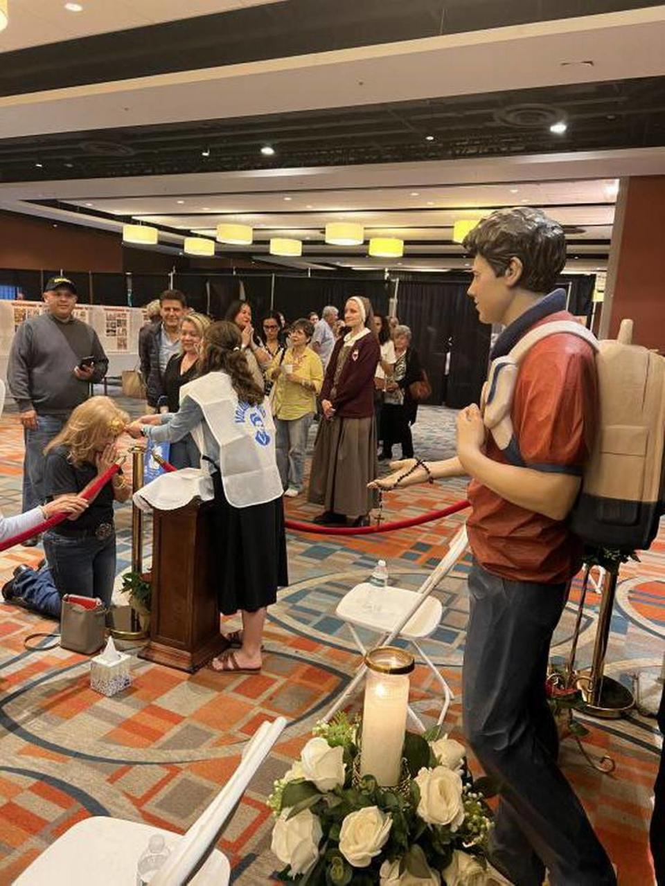 People line up to pray to a relic of Carlo Acutis during an exhibit organized by the Archdiocese of Miami in 2022. Acutis is set to become the first millennial saint in the Catholic Church.