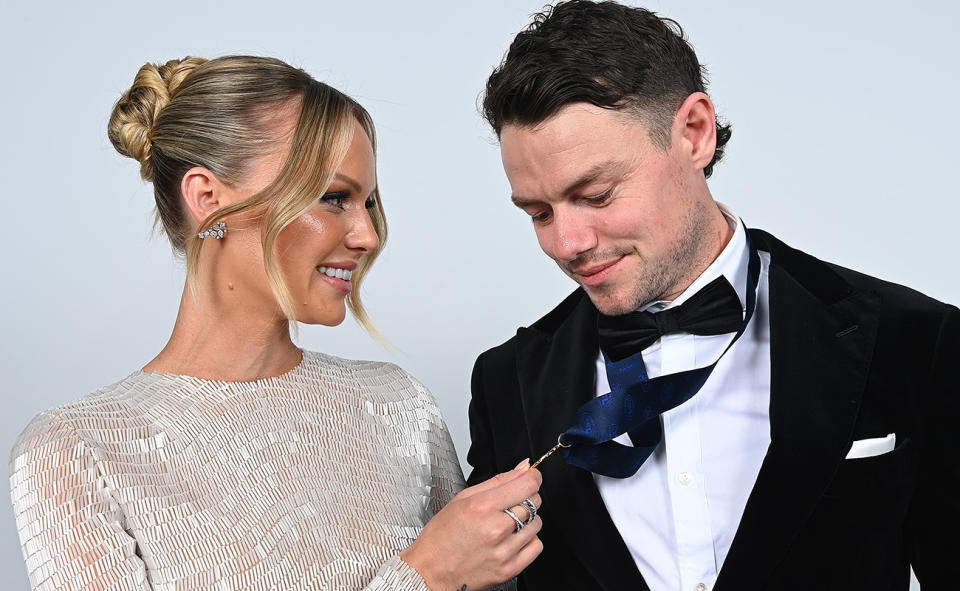 Lachie Neale and wife with the Brownlow Medal.