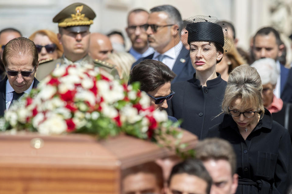 Family members of former Italian premier Silvio Berlusconi, daughter Eleonora, center, daughter Marina, right, son Pier Silvio, center, and brother Paolo, left, follow his casket at the end of his state funeral in Milan's Duomo Gothic-era Cathedral, Italy, Wednesday, June 14, 2023. Berlusconi died at the age of 86 on Monday in a Milan hospital where he was being treated for chronic leukemia. (Claudio Furlan/LaPresse via AP)