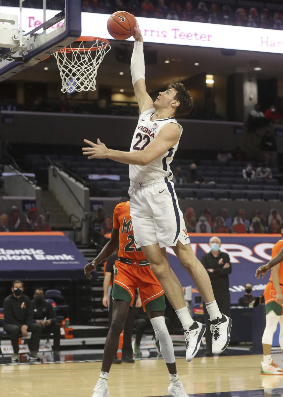 Virginia center Francisco Caffaro (22) dunks next to Miami guard Kameron McGusty (23) during an NCAA college basketball game Monday in Charlottesville, Va. (Andrew Shurtleff/The Daily Progress via AP, Pool)