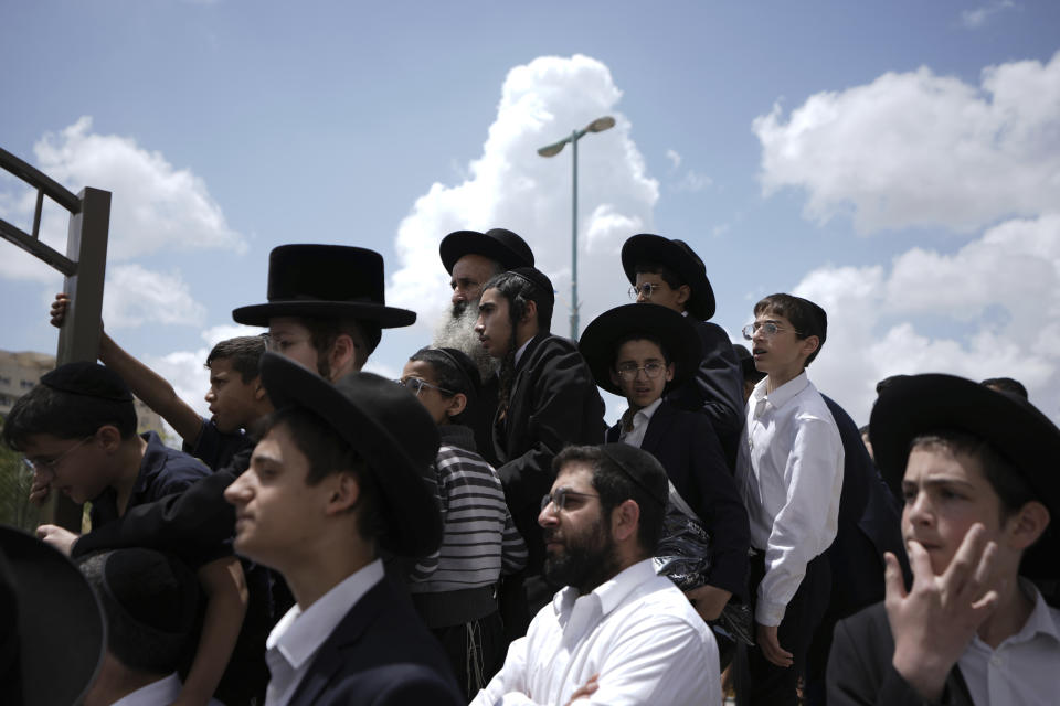 Ultra-Orthodox Jewish mourners gather at the funeral for Yonatan Havakuk and Boaz Gol, a day after they were killed in a stabbing attack in Elad, Israel, Friday, May 6, 2022. Israeli security forces waged a massive manhunt Friday for two Palestinians suspected of carrying out the stabbing attack on Thursday near Tel Aviv that left three Israelis dead. (AP Photo/Ariel Schalit)