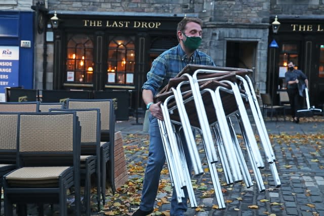 Man stacking tables