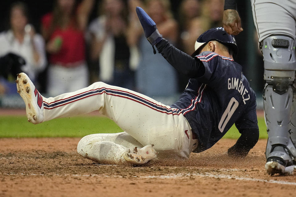 Cleveland Guardians' Andres Gimenez slides home with the winning run on a sacrifice fly hit by Bo Naylor in the ninth inning of a baseball game against the Chicago White Sox, Tuesday, July 2, 2024, in Cleveland. (AP Photo/Sue Ogrocki)