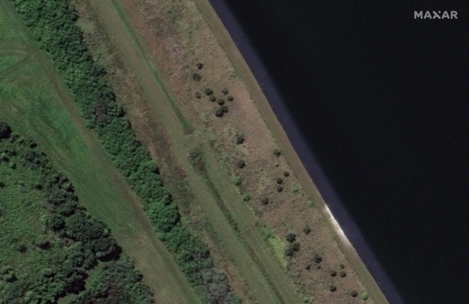 This Oct. 30, 2020, image provided by Maxar Technologies shows a view of a retaining pond at the 77-acre Piney Point reservoir in Manatee County, just south of the Tampa Bay area, in Florida, before a leak was discovered. (Satellite image ©2021 Maxar Technologies via AP)