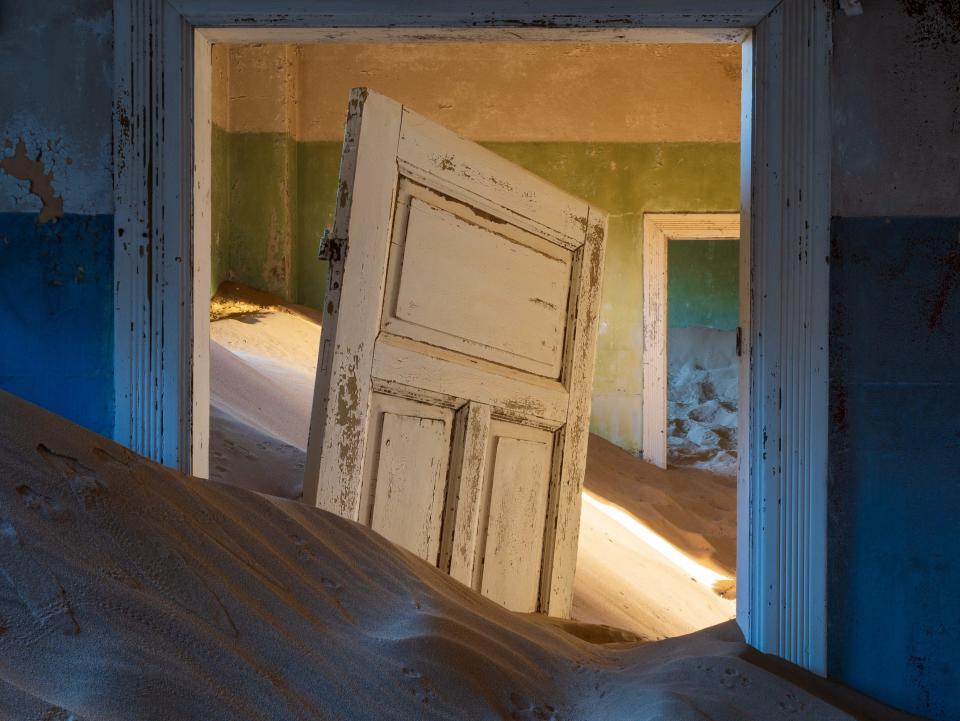 A doorframe buried in sand in Kolmanskop in Namibia.