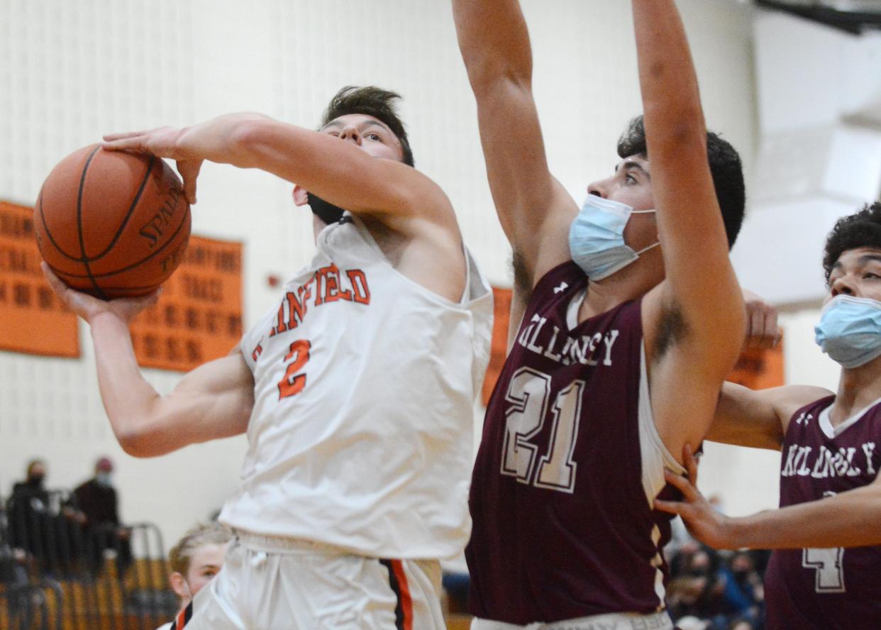 Plainfield' Tyler Nordstrom goes up for a shot against Killingy's Yianni Baribeau at Plainfield High School.