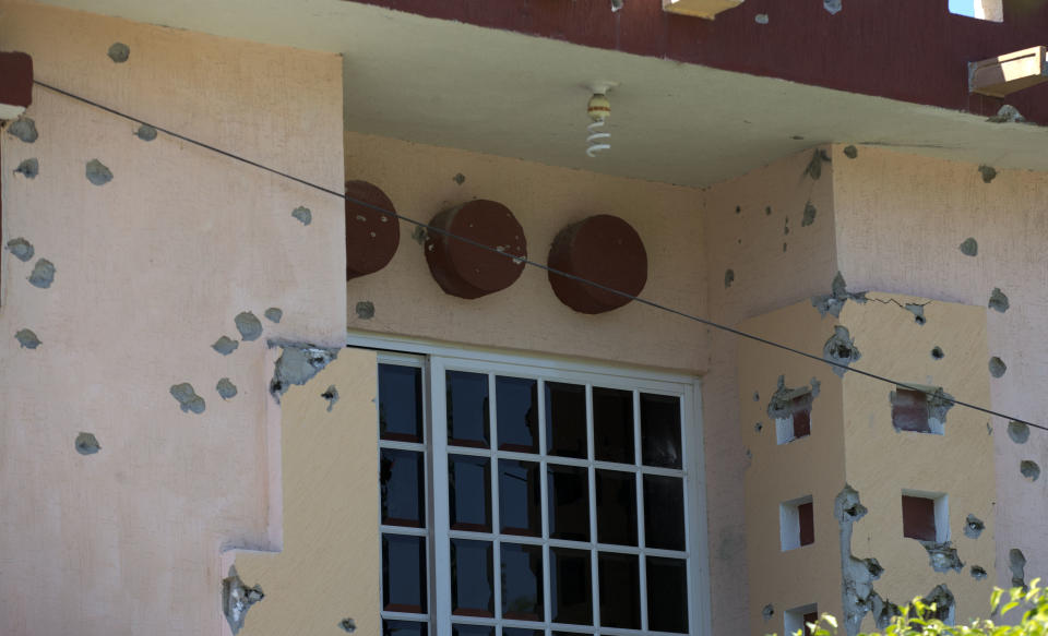 A house is riddled with bullet holes after clashes between the Self-Defense Council of Michoacan, (CAM), and members of the Knights Templar drug cartel a day earlier in Nueva Italia, Mexico, Monday, Jan. 13, 2014. A day earlier the self-defenses encountered resistance as they tried to rid the town of the Knights Templar drug cartel while the government announced today that federal forces will take over security in a large swath of a western Mexico that has been hard hit by violence. (AP Photo/Eduardo Verdugo)