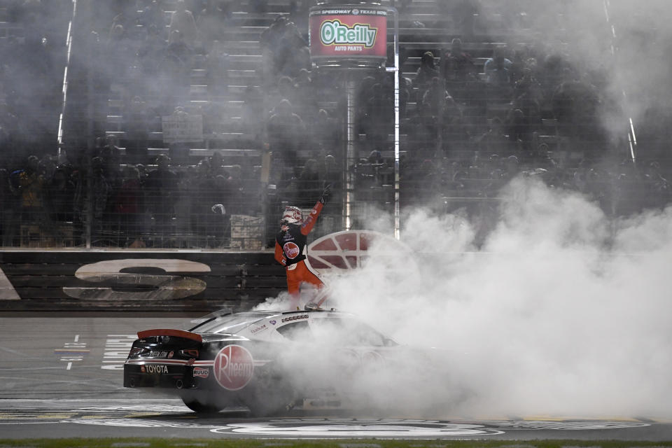 Christopher Bell stands on his car celebrating his win in the NASCAR Xfinity Series auto race at Texas Motor Speedway in Fort Worth, Texas, Saturday, Nov. 2, 2019. (AP Photo/Larry Papke)