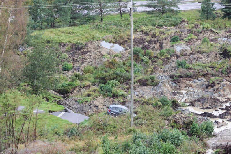 A view of a car and partially collapsed motorway following a landslide, near Stenungsund