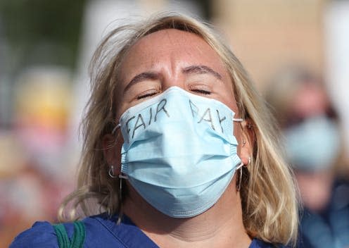 <span class="caption">It's a living, just: an NHS worker marching for a pay rise, July 2020.</span> <span class="attribution"><span class="source">Yui Mok/PA Wire/PA Images</span></span>