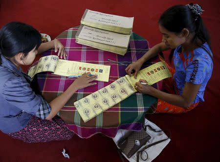 Women label ballots at a polling station ahead of tomorrow's general election in Mandalay, Myanmar, November 7, 2015. REUTERS/Olivia Harris