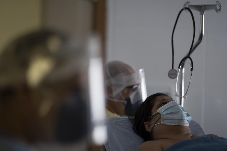 Trabajadores médicos trasladan a una nueva paciente con coronavirus para que sea tratada en el Hospital Ernesto Che Guevara en Marica, Brasil, el jueves 21 de mayo de 2020. (Foto AP/Leo Correa)