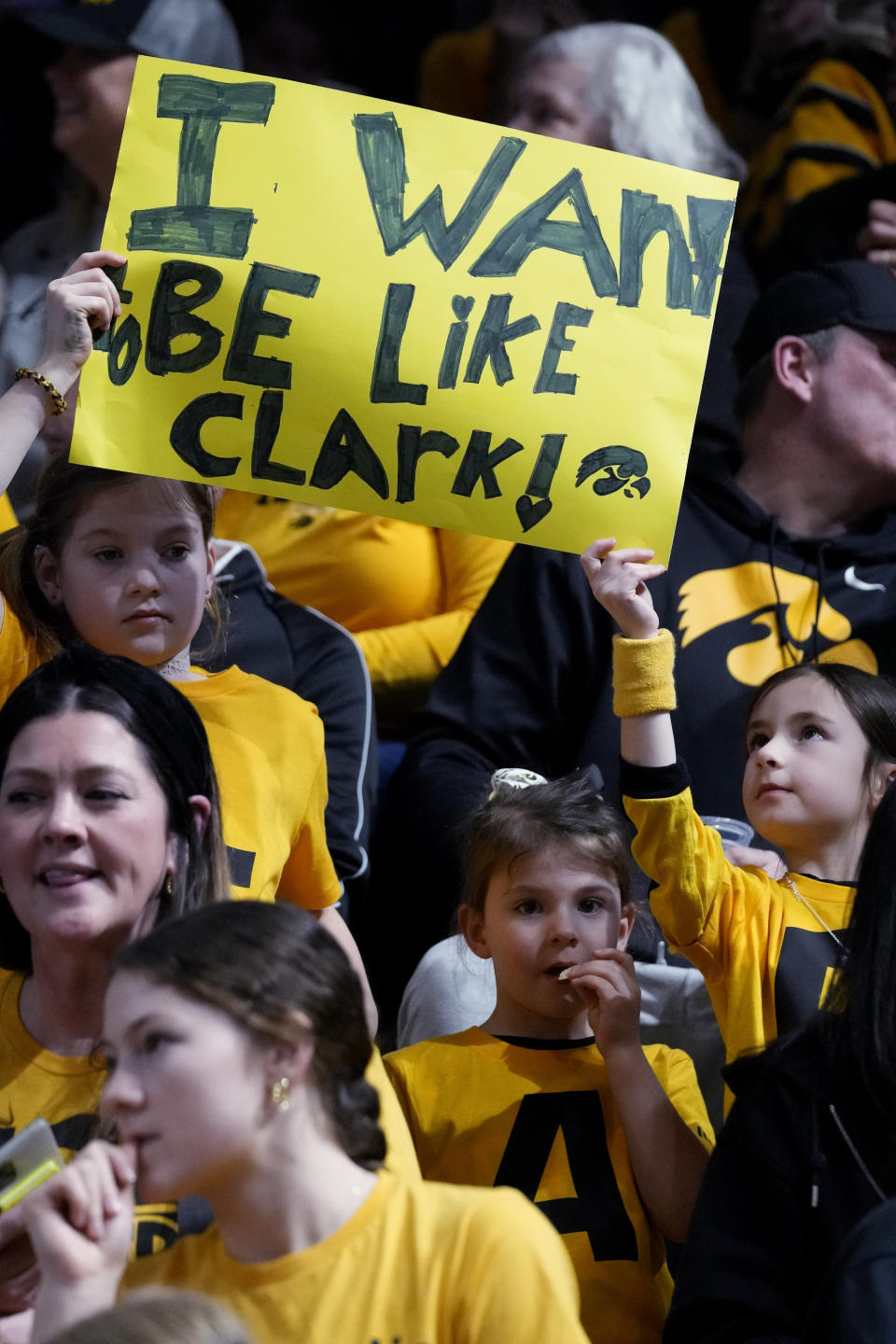 Supporters hold a sign for Iowa guard Caitlin Clark before an NCAA college basketball game between Iowa and Northwestern in Evanston, Ill., Wednesday, Jan. 31, 2024. (AP Photo/Nam Y. Huh)