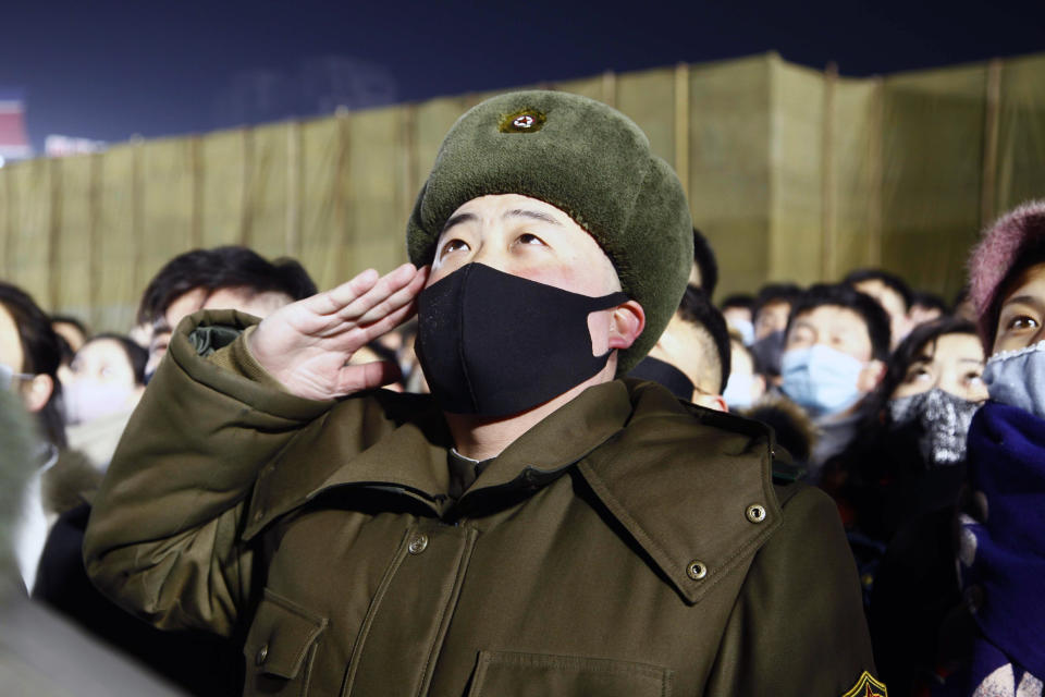 A man salutes during the national flag-hoisting ceremony during celebrations to mark the New Year, at Kim Il Sung Square in Pyongyang, North Korea, early Friday, Jan., 1, 2021. (AP Photo/Jon Chol Jin)