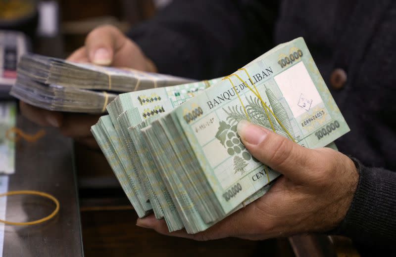 FILE PHOTO: A money exchange vendor displays Lebanese pound banknotes at his shop in Beirut