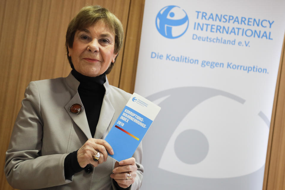 Edda Mueller, chairwoman of Transparency International Germany e.V. poses for the media with the Corruption Perceptions Index 2018, prior to the presentation of the yearly report at a news conference in Berlin, Germany, Tuesday, Jan. 29, 2019. The flyer reading: 'Corruption Perceptions Index 2018'. (AP Photo/Markus Schreiber)