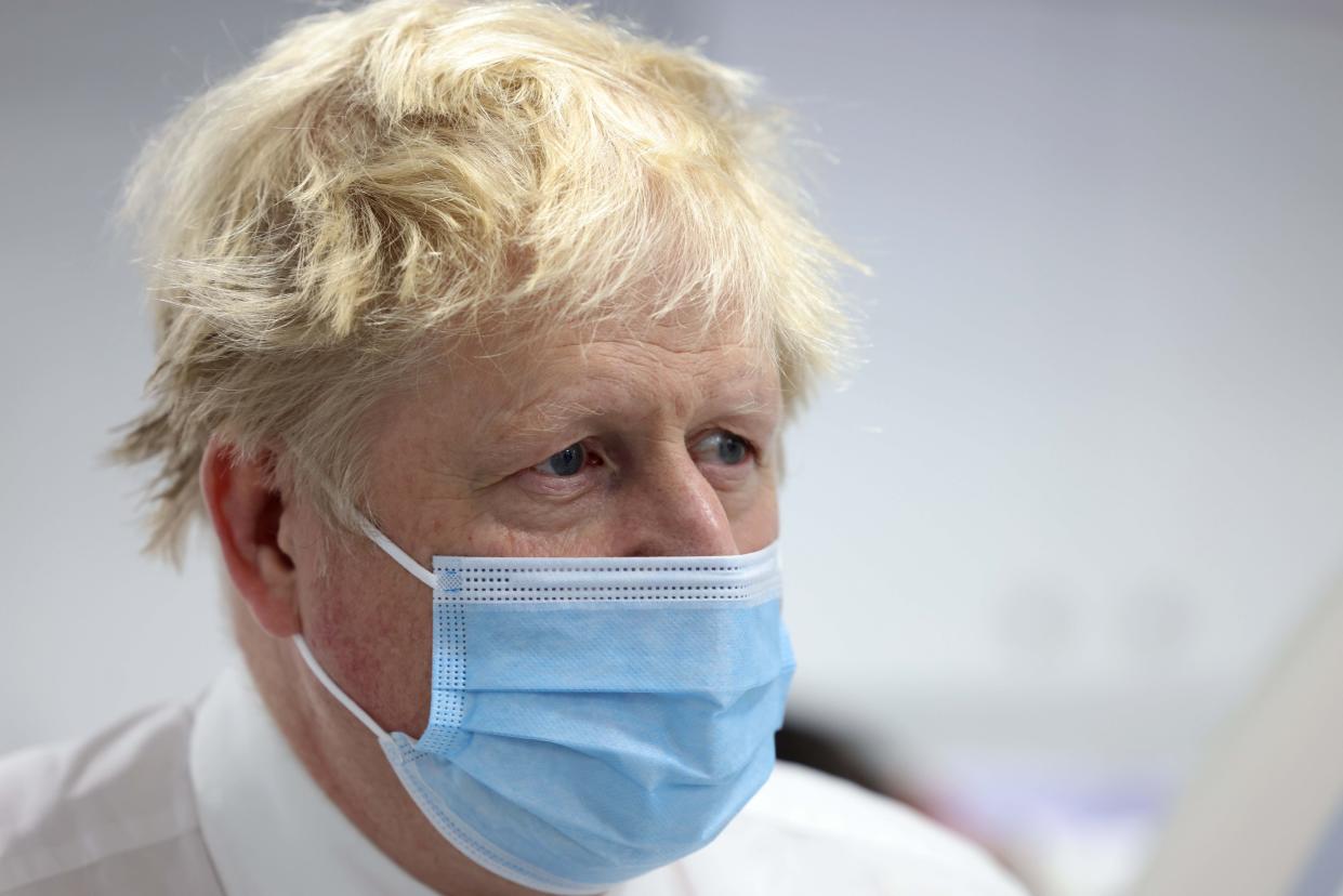 Britain's Prime Minister Boris Johnson looks on during a visit to Finchley Memorial Hospital, in North London, Tuesday, Jan. 18, 2022. (Ian Vogler, Pool Photo via AP)