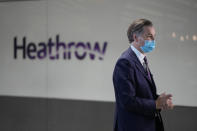 The CEO of Heathrow Airport John Holland-Kaye gives a television interview at Terminal 5 of Heathrow Airport in London, Monday, Aug. 2, 2021. Travelers fully vaccinated against coronavirus from the United States and much of Europe were able to enter Britain without quarantining starting today, a move welcomed by Britain's ailing travel industry. (AP Photo/Matt Dunham)