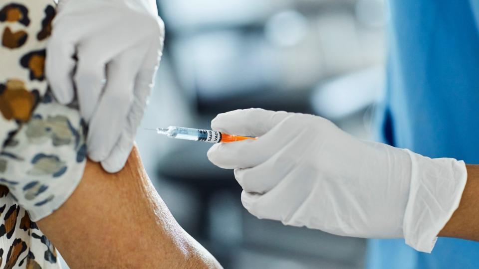 Cropped image of nurse injecting Covid-19 Vaccine to a patient. 