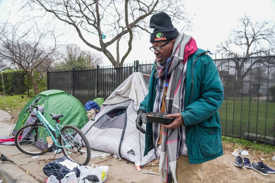 Glenn Wade enjoys his food from Our Shared Kitchen in downtown Austin on Monday. Founder Ari Vinograd and her team cooked and distributed 300 meals to people living outside. They plan to continue that service every day this week because of the cold weather.