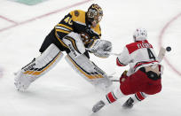 Boston Bruins goaltender Tuukka Rask (40), of Finland, clears the puck as he is pressured by Carolina Hurricanes' Haydn Fleury (4) during the first period in Game 2 of the NHL hockey Stanley Cup Eastern Conference final series, Sunday, May 12, 2019 in Boston. (AP Photo/Charles Krupa)