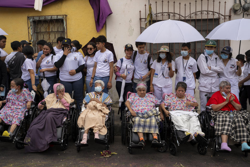 Faithful, accompanied by their nurses and volunteers, wait to watch the annual Jesus del Consuelo procession, in Guatemala City, Saturday, March 23, 2024. As more than 100 men carrying a religious float halted nearby, Cardinal Álvaro Ramazzini lost no time in calling for social justice — the hallmark of the Catholic bishop’s decades-long frontline ministry. (AP Photo/Moises Castillo)