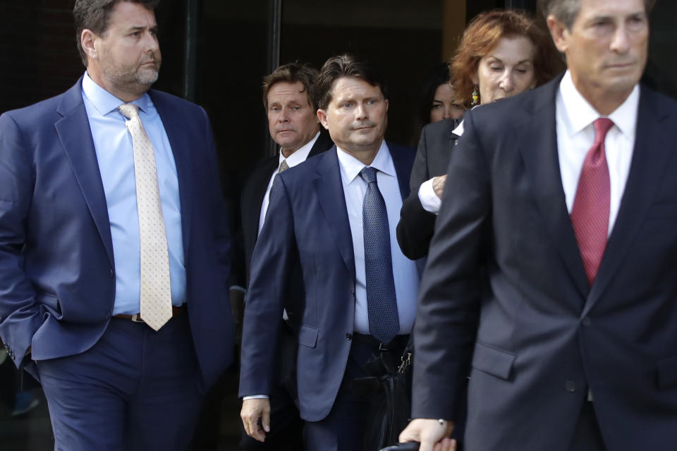 Devin Sloane, middle, leaves federal court after his sentencing in a nationwide college admissions bribery scandal, Tuesday, Sept. 24, 2019, in Boston. (AP Photo/Elise Amendola)