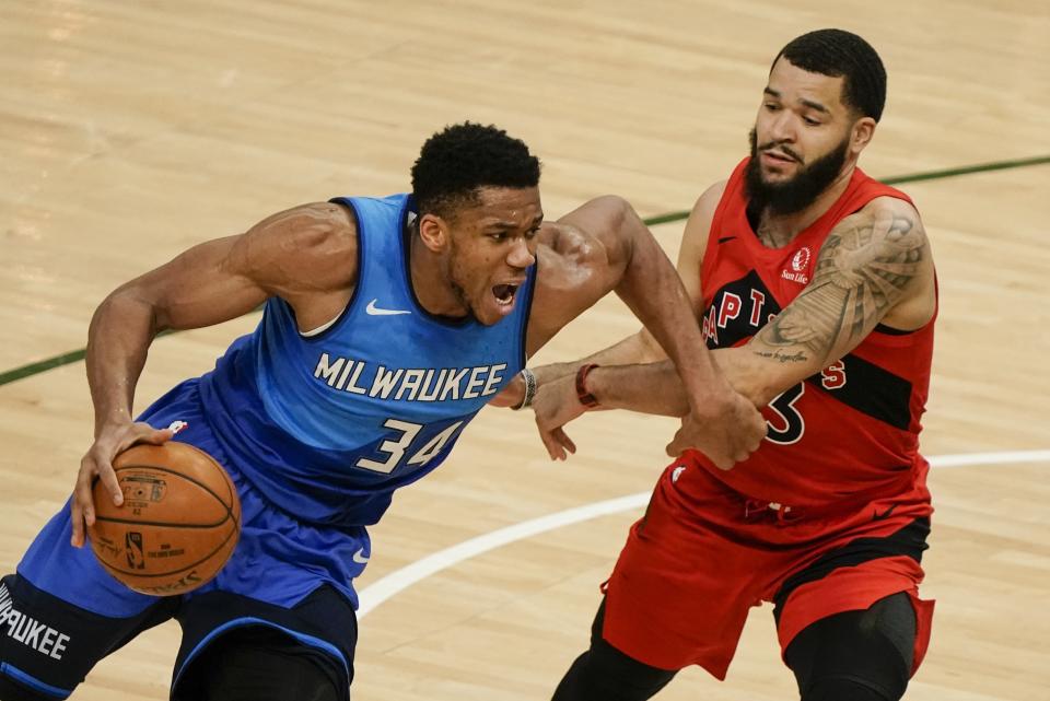 Milwaukee Bucks' Giannis Antetokounmpo drives past Toronto Raptors' Fred VanVleet during the first half of an NBA basketball game Thursday, Feb. 18, 2021, in Milwaukee. (AP Photo/Morry Gash)