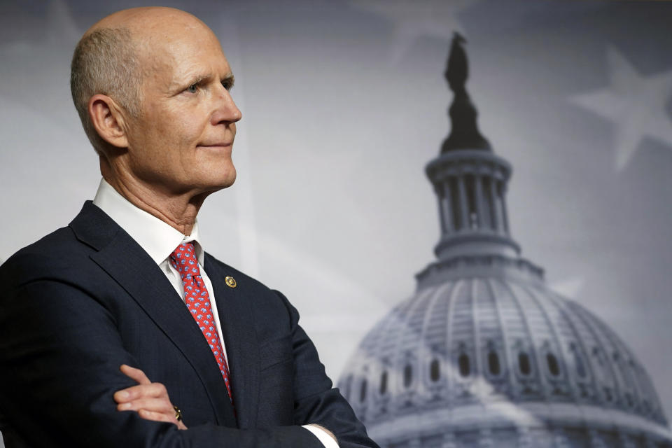 FILE - Sen. Rick Scott, R-Fla., listens during a news conference on the budget bill, Dec. 20, 2022, on Capitol Hill in Washington. Former Democratic U.S. Rep. Debbie Mucarsel-Powell announced Tuesday, Aug. 22, 2023, she will seek the nomination to challenge Scott in 2024, a campaign that will be a test to see if Florida Democrats can fare better during a presidential election in a state that is increasingly Republican. (AP Photo/Mariam Zuhaib, File)