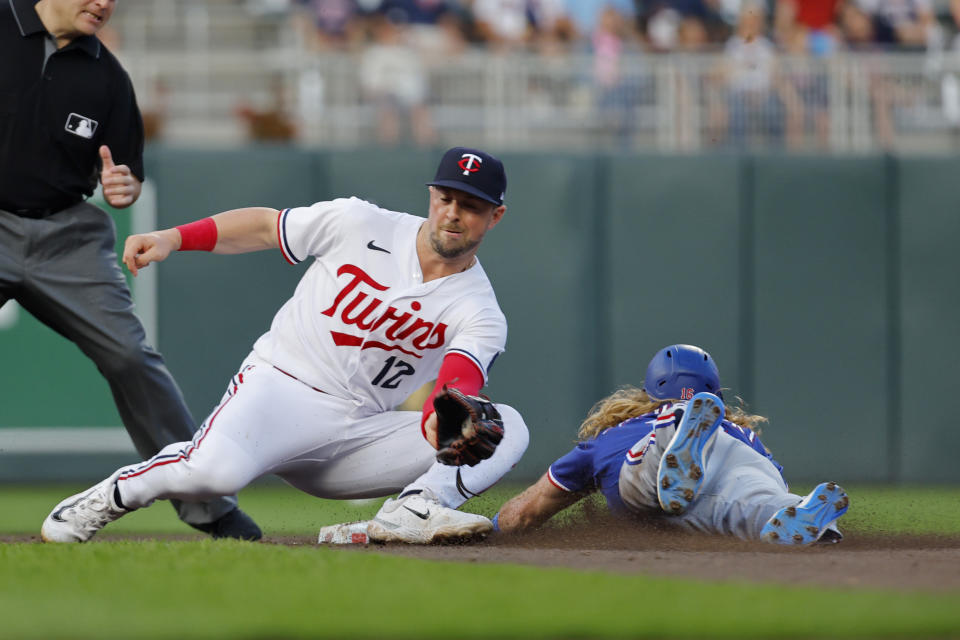 Texas Rangers' Travis Jankowski, right, steals second base as Minnesota Twins second baseman Kyle Farmer catches the throw during the fifth inning of a baseball game Thursday, Aug. 24, 2023, in Minneapolis. (AP Photo/Bruce Kluckhohn)