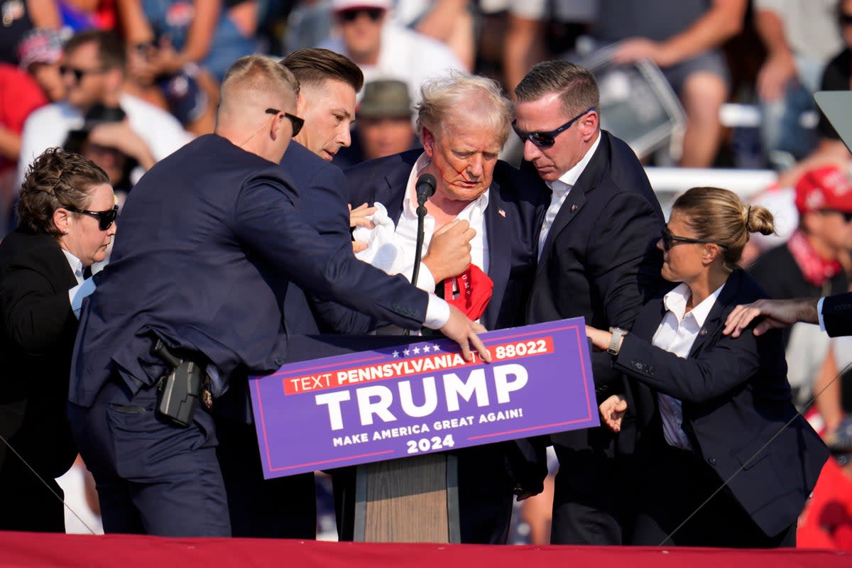 Secret Service rush to get Donald Trump off stage during a rally in Pennslyvania on July 13, 2024 (AP)