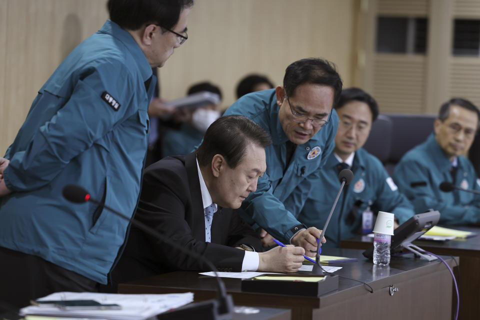 In this photo provided by South Korean Presidential Office, South Korean President Yoon Suk Yeol, second left, attends during the National Security Council (NSC) meeting at the presidential office in Seoul, South Korea, Wednesday, Nov. 2, 2022. Air raid sirens sounded in South Korea after the North fired about a dozen missiles in its direction Wednesday, at least one of them landing near the rivals' tense sea border. (South Korea Presidential Office via AP)