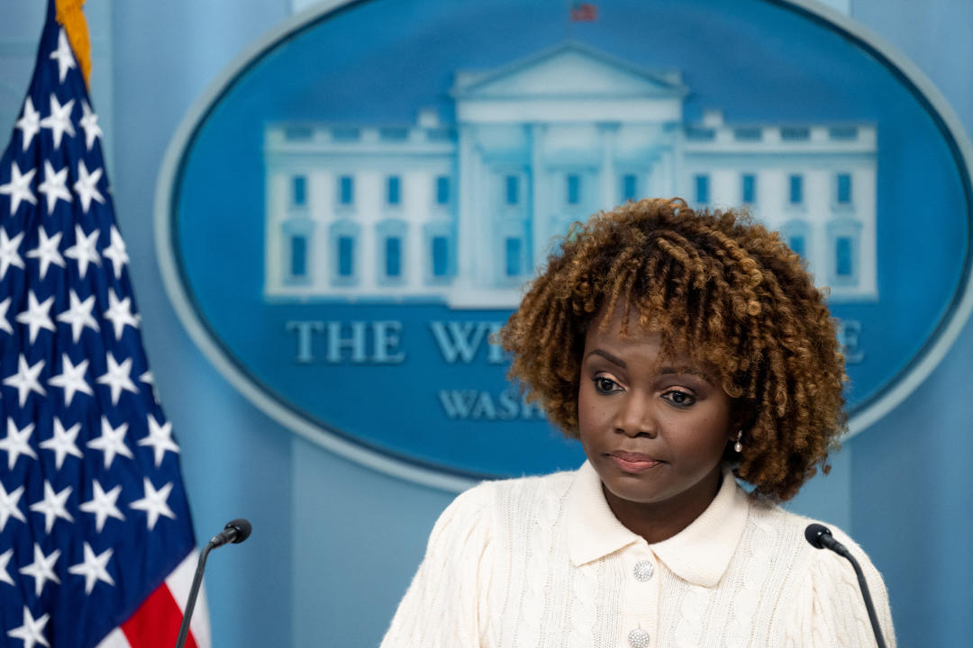 White House press secretary Karine Jean-Pierre stands at a podium.