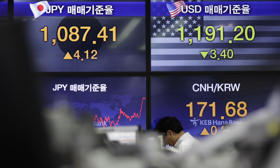 A currency trader walks near the screens showing the foreign exchange rates at the foreign exchange dealing room in Seoul, South Korea, Friday, May 24, 2019. Asian shares were mostly lower on Friday as worries that the standoff between the U.S. and China over trade might expand put investors in a selling mood. (AP Photo/Lee Jin-man)