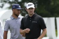 Xander Schauffele, left, and his teammate Patrick Cantlay walk off the 9th green during the second round of the PGA Zurich Classic golf tournament at TPC Louisiana in Avondale, La., Friday, April 21, 2023. (AP Photo/Gerald Herbert)