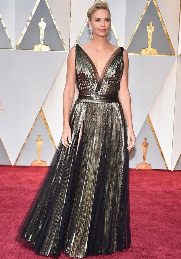 Charlize Theron mixed gold with black for this stunning ball gown. Photo: Getty