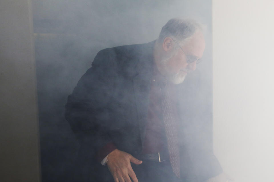 Richard DeWeese, Supervisor of the Aeromedical Engineering Sciences Section at the FAA Civil Aerospace Medical Institute, exits a smoke-filled simulator during a demonstration at the Mike Monroney Aeronautical Center, Thursday, Oct. 17, 2019, in Oklahoma City. Federal researchers, using 720 volunteers in Oklahoma City, will test whether smaller seats and crowded rows slow down airline emergency evacuations. (AP Photo/Sue Ogrocki)