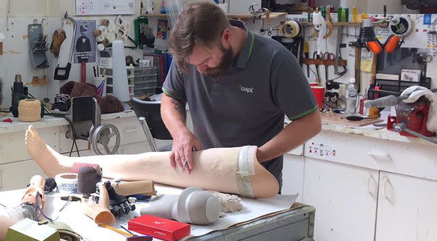 Technicians apply the finishing touches to Denique's new leg. Picture: 7News