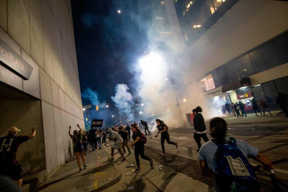 Protesters scramble on 4th Street as police blocked both ends of the block and fired chemical agents at the trapped protesters.